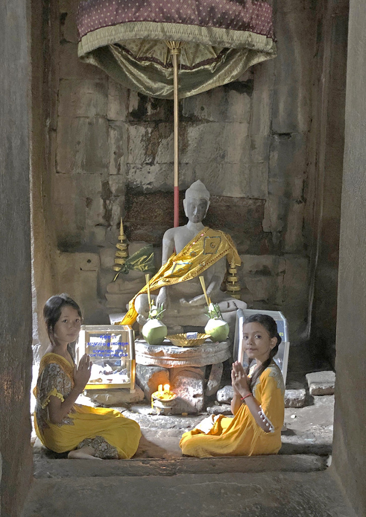 I came around a corner at the Bayon and saw these two girls posing for their mom, who kindly let me take a picture too.